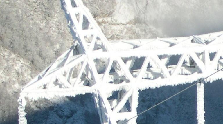 Snow-covered electricity tower