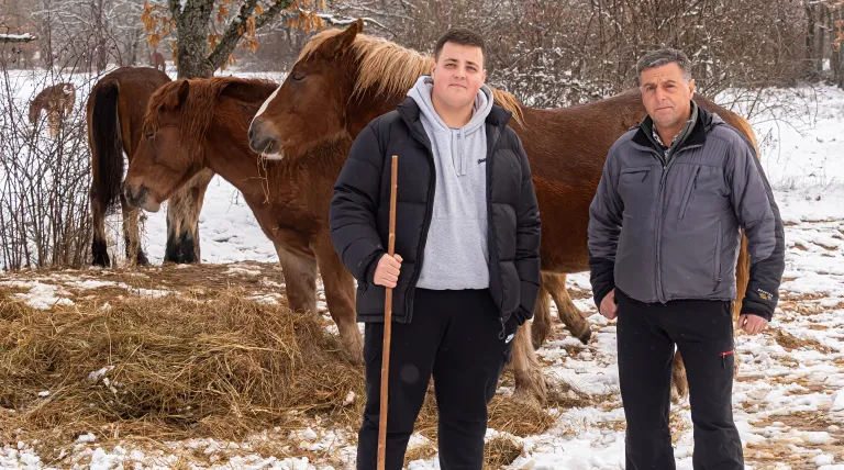 Ángel Díaz 'Gelo' and his son Rubén are grazing with their horses under the grass in Rabanal de Fenar
