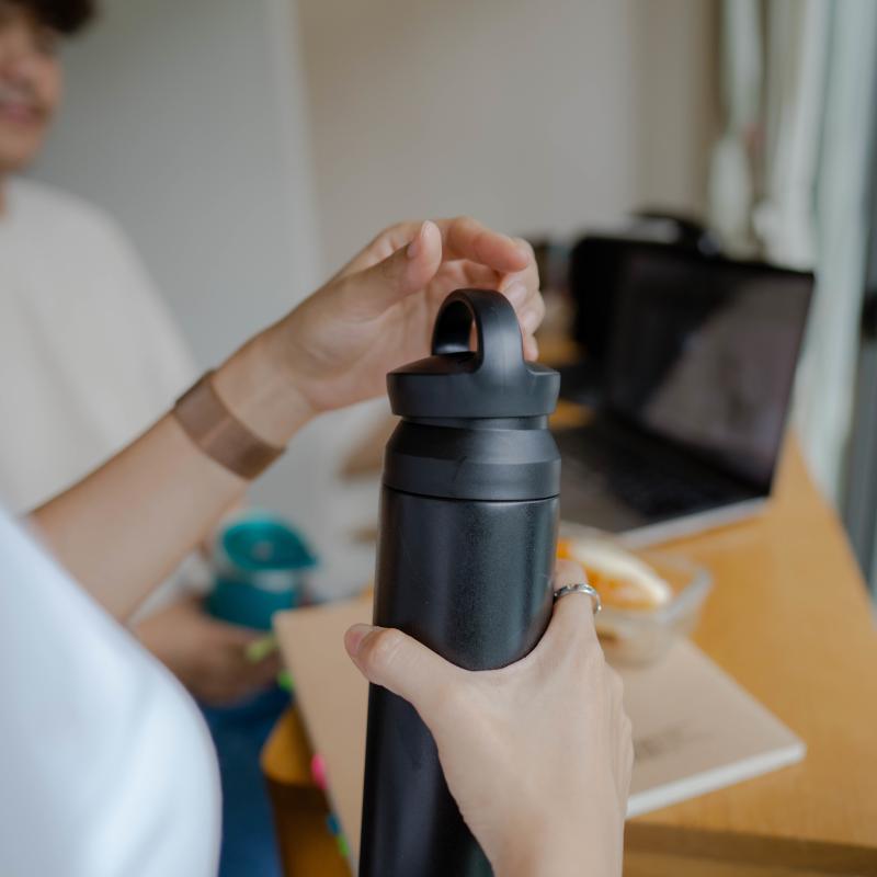 Woman holding a recycled plastic bottle